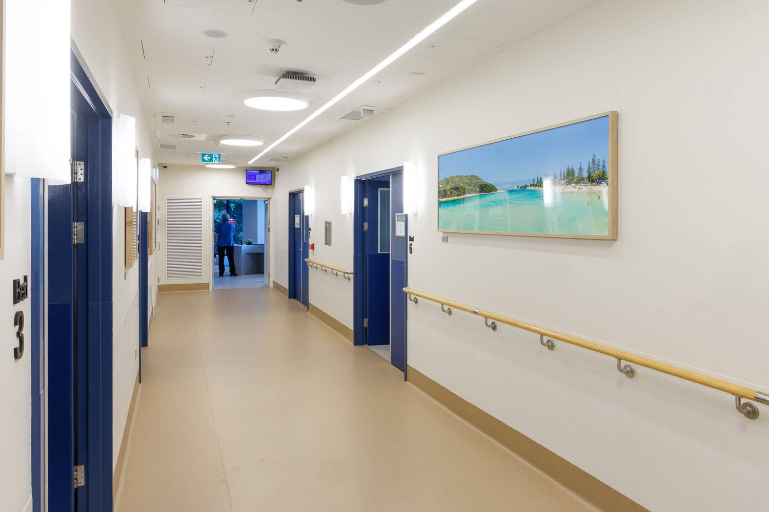 Jon Wright beside his framed Tallebudgera Creek print in the H2 East corridor at Robina Hospital