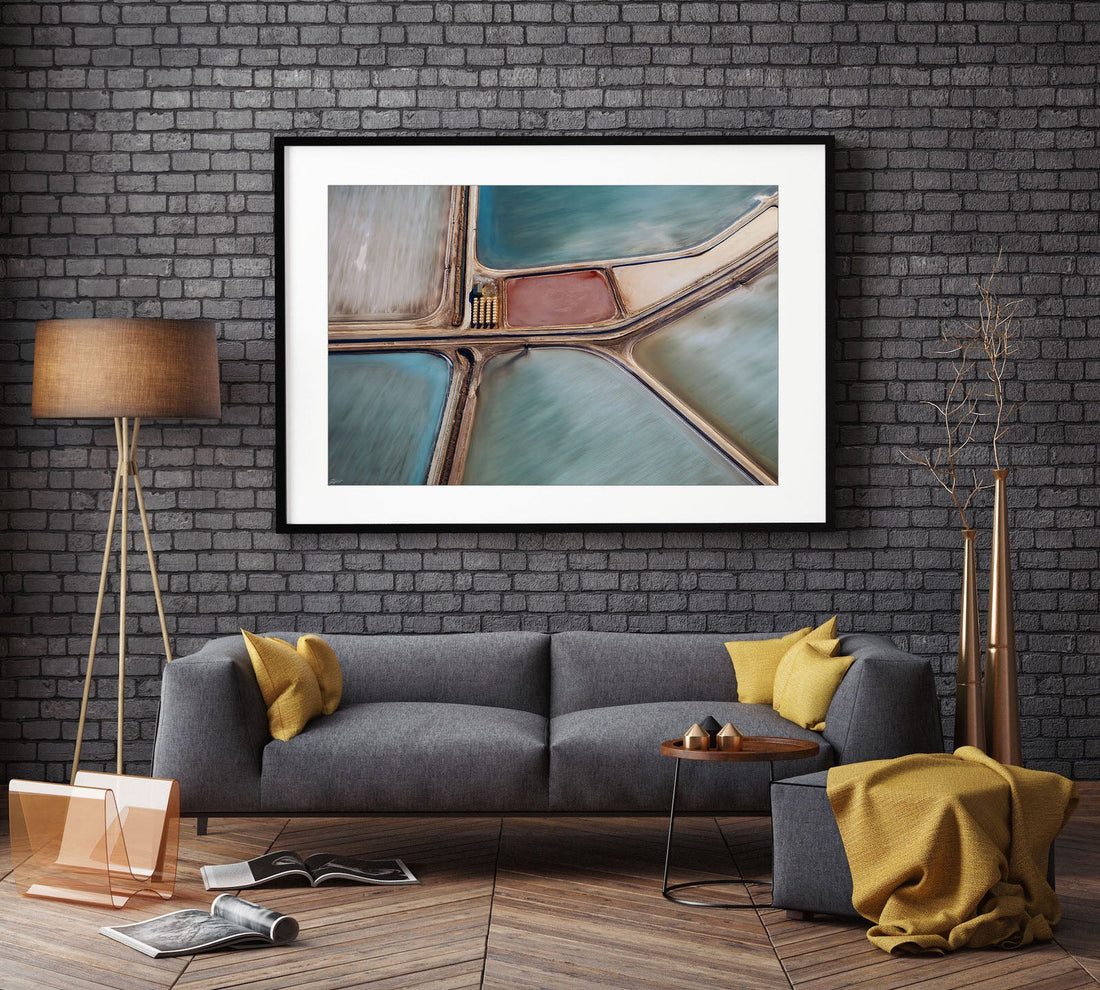 Abstract aerial print hanging above a couch in a black frame, Centre of Attention