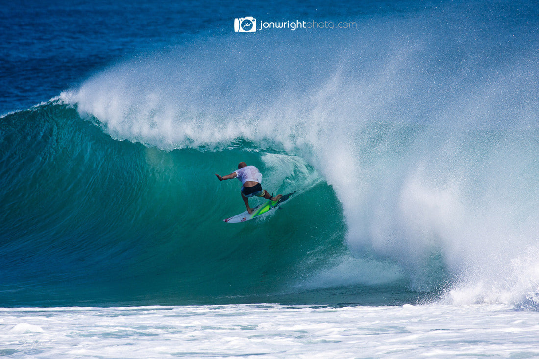 Mick Fanning deep inside a large barrelling wave at Kirra Beach, Gold Coast.