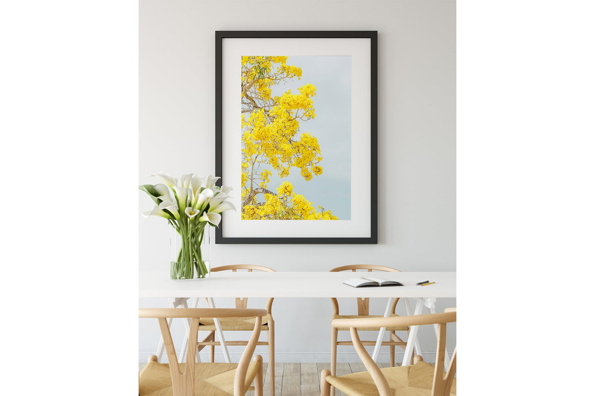 The Golden Trumpet print shown framed in black.