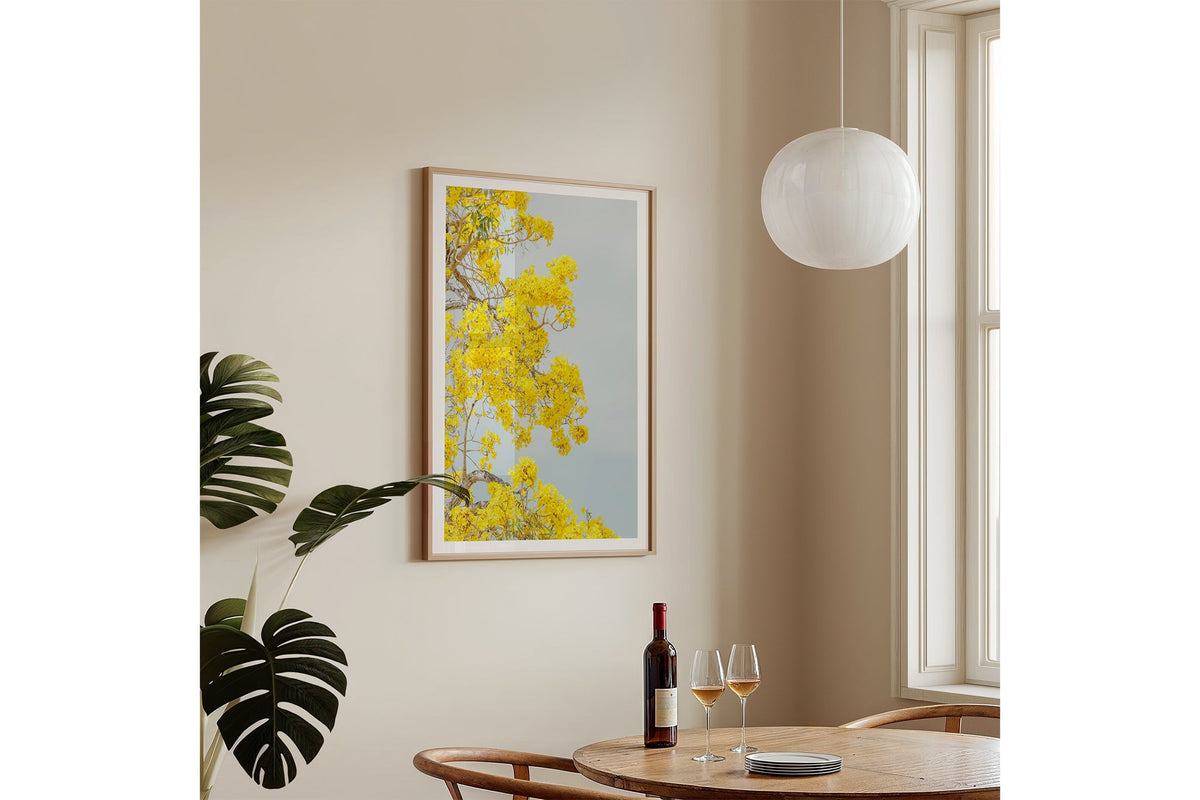 The Golden Trumpet print shown framed in oak, hung on a wall.