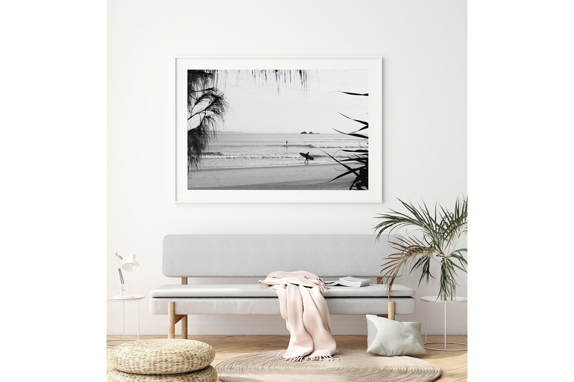Byron Bay black and white surf print shown framed in white above a bench seat.