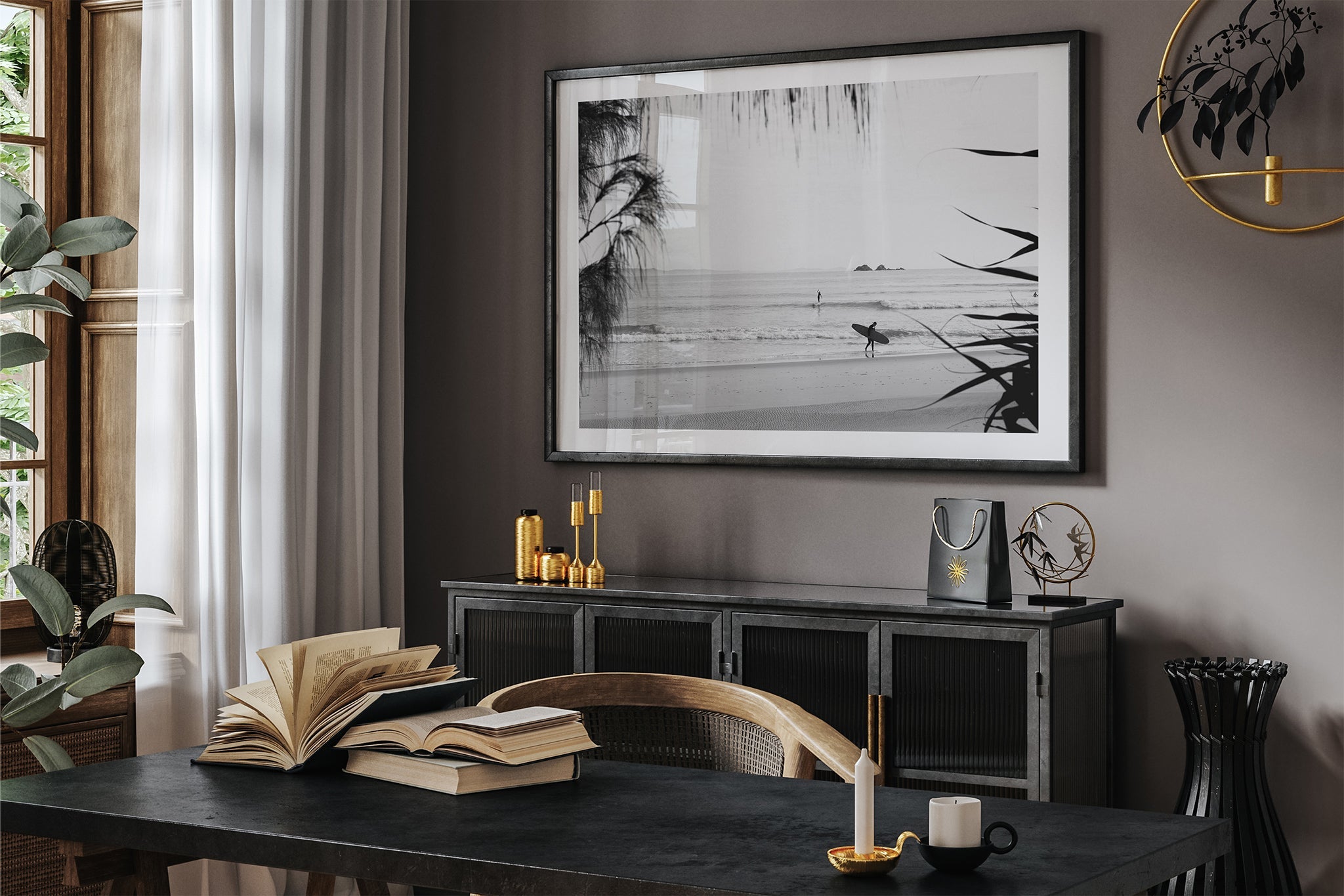 Byron Bay black and white surf print shown framed in black in a dark room.