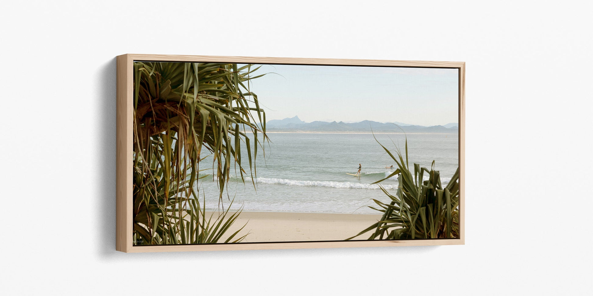 Byron Bay panoramic surf print shown as an oak float frame canvas.