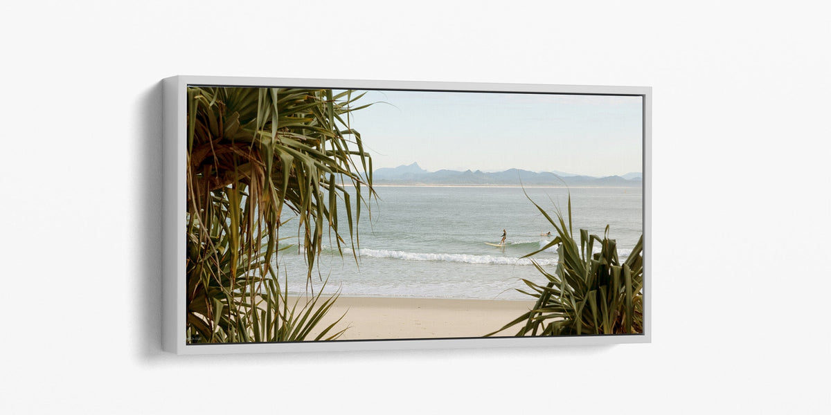 Byron Bay panoramic surf print shown as a white float frame canvas.