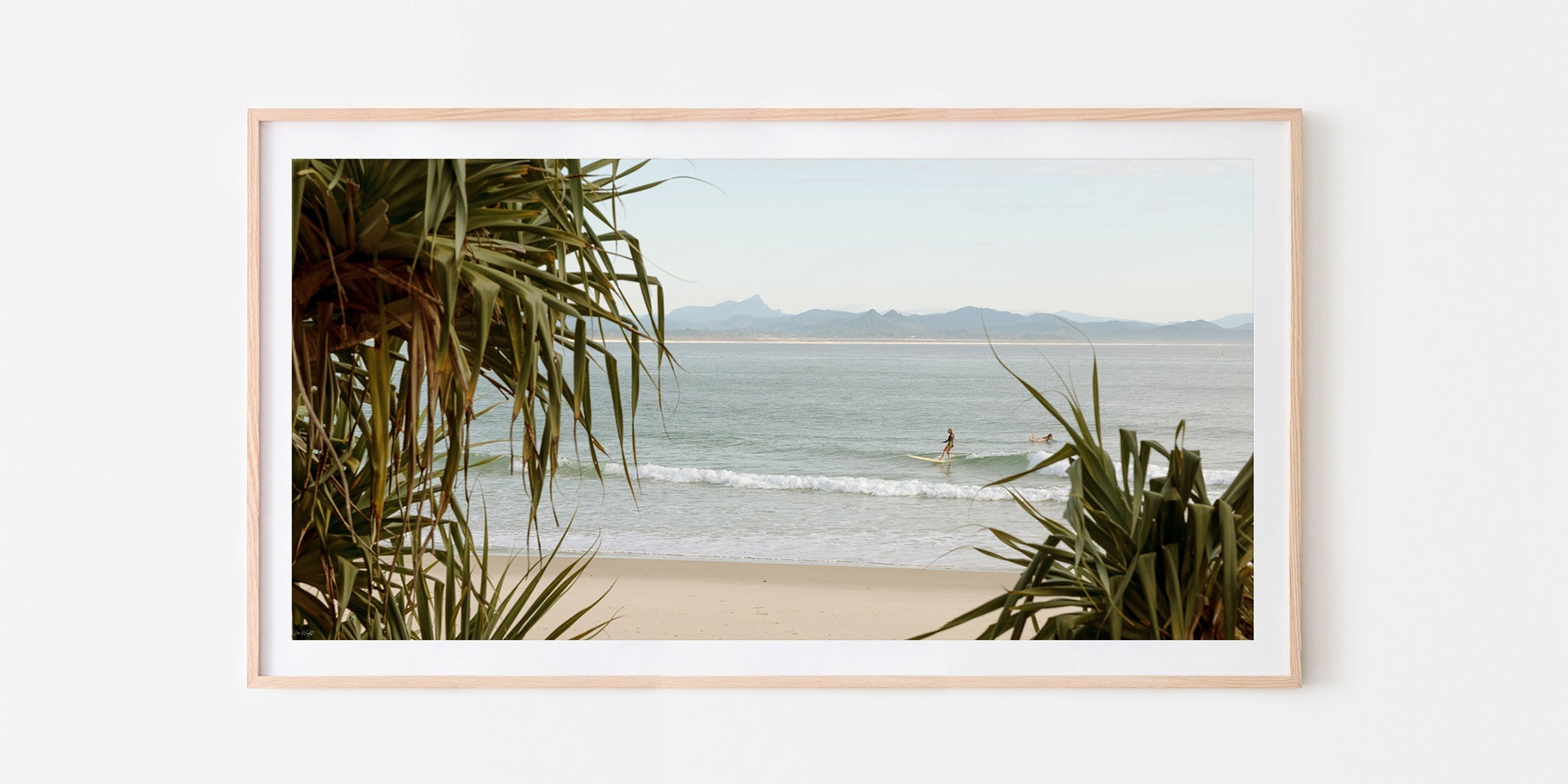Byron Bay panoramic surf print shown framed in oak.