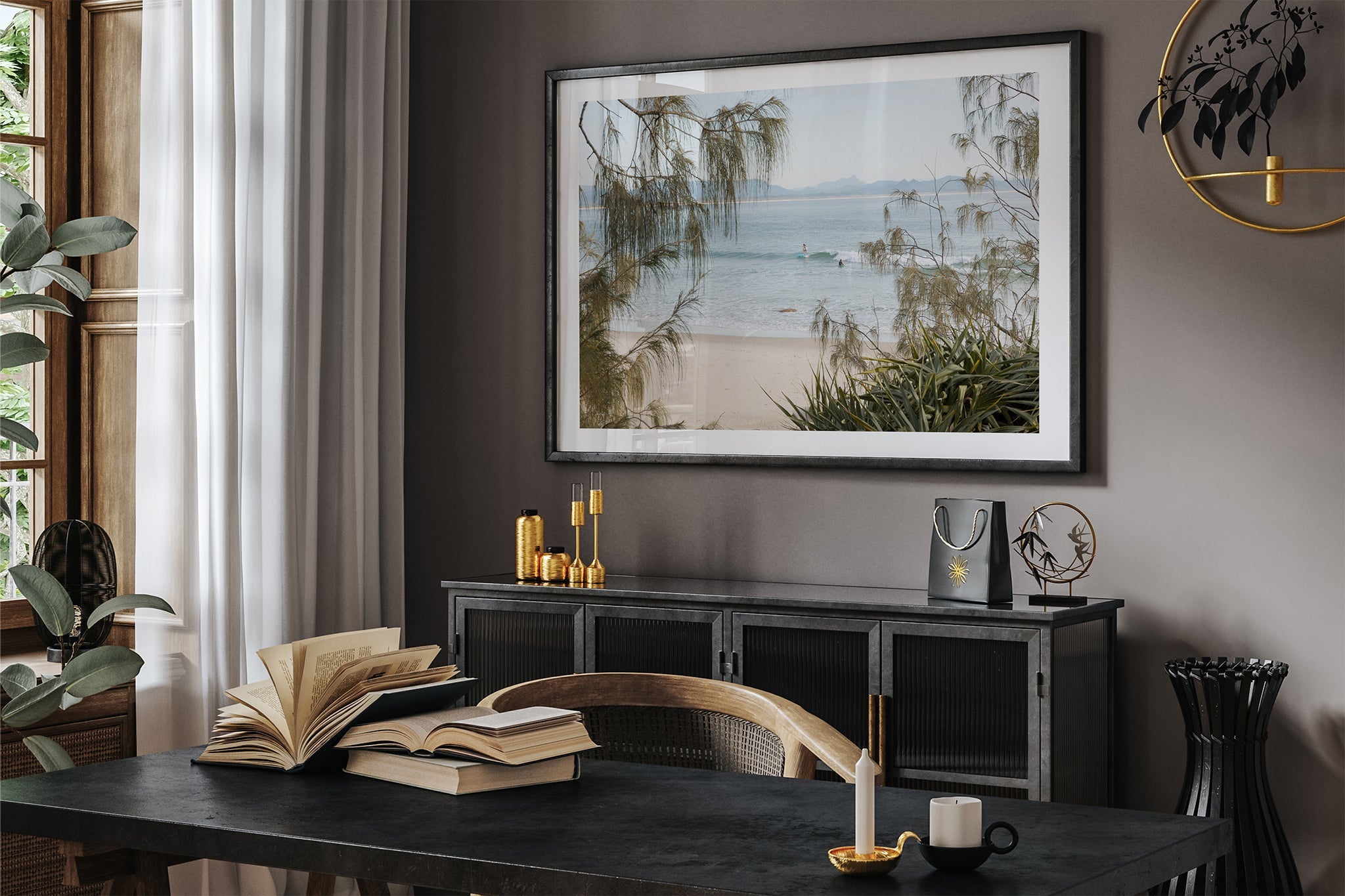 Byron Bay coastal print shown framed in black in a dark room.