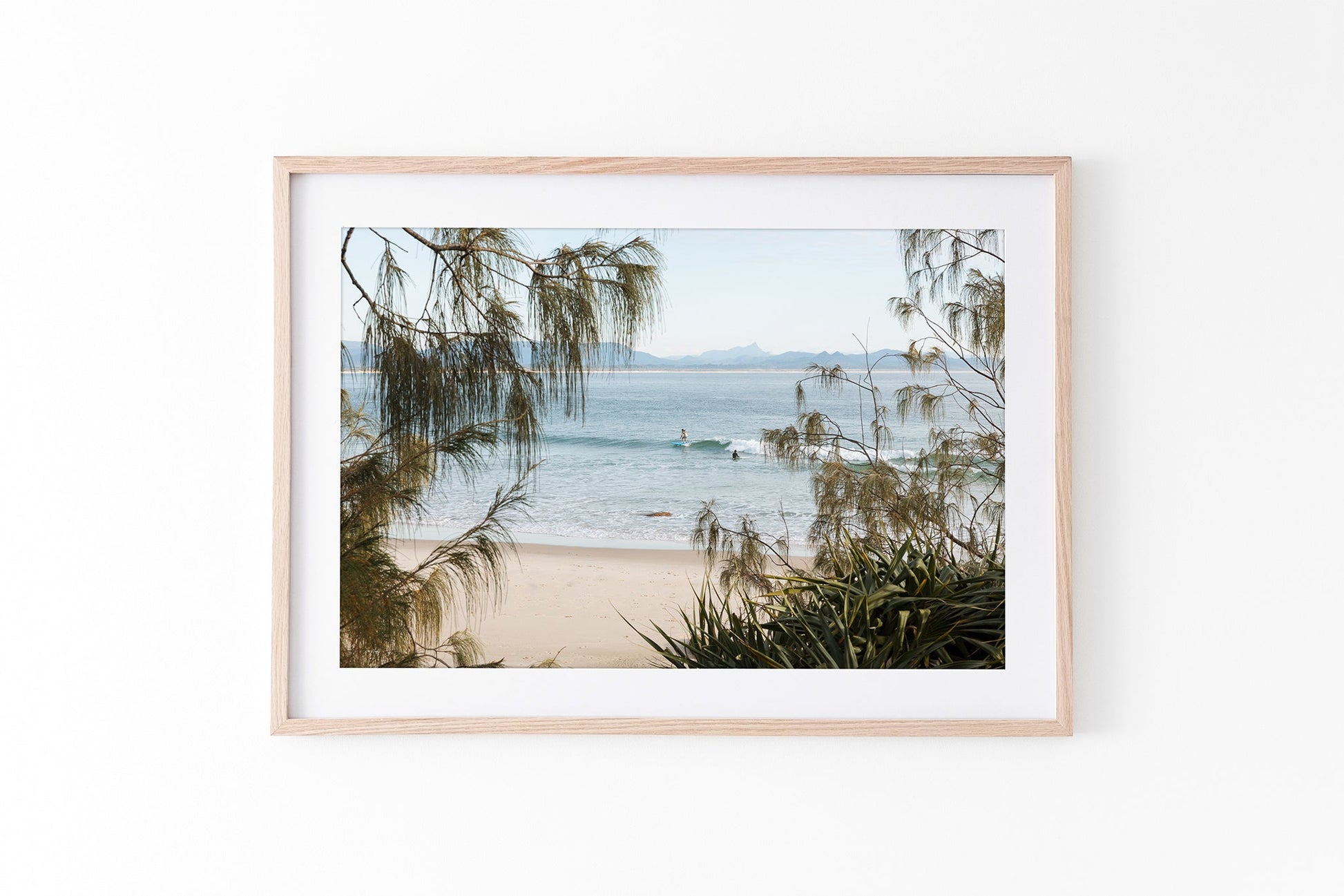 Byron Bay coastal print shown framed in oak.