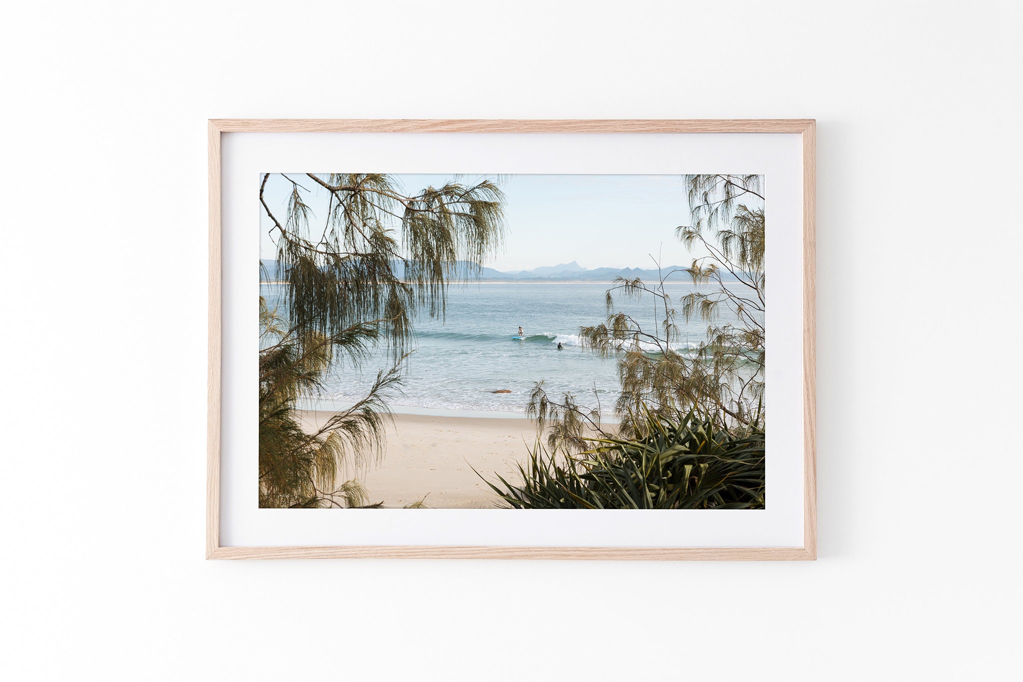 Byron Bay coastal print shown framed in oak.