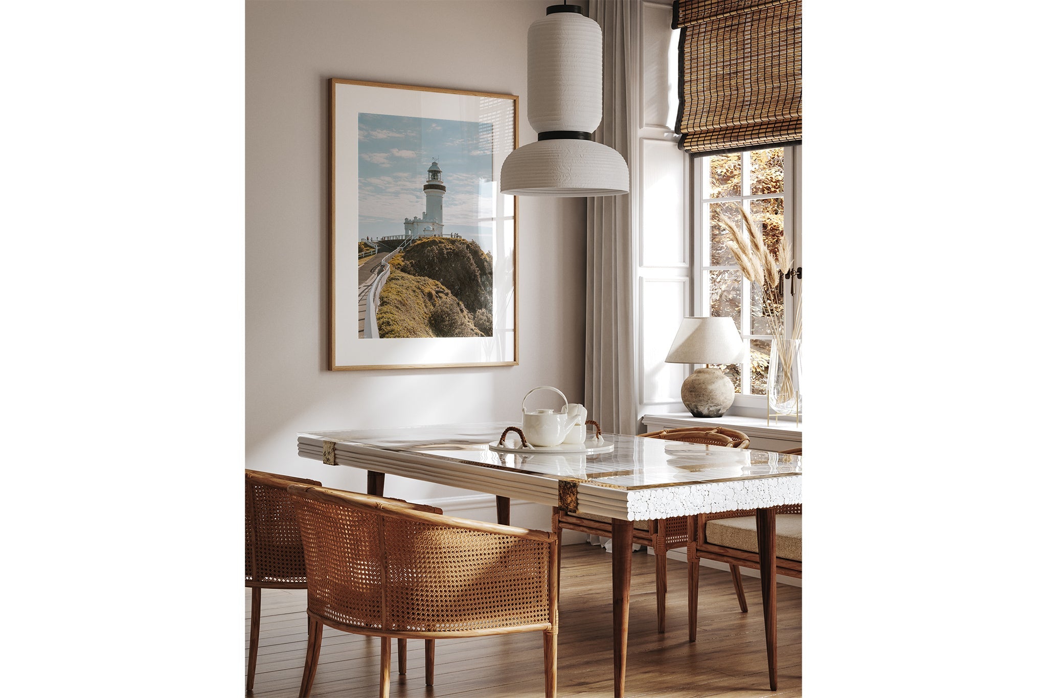 Cape Byron Lighthouse print shown framed in oak above a dining table.