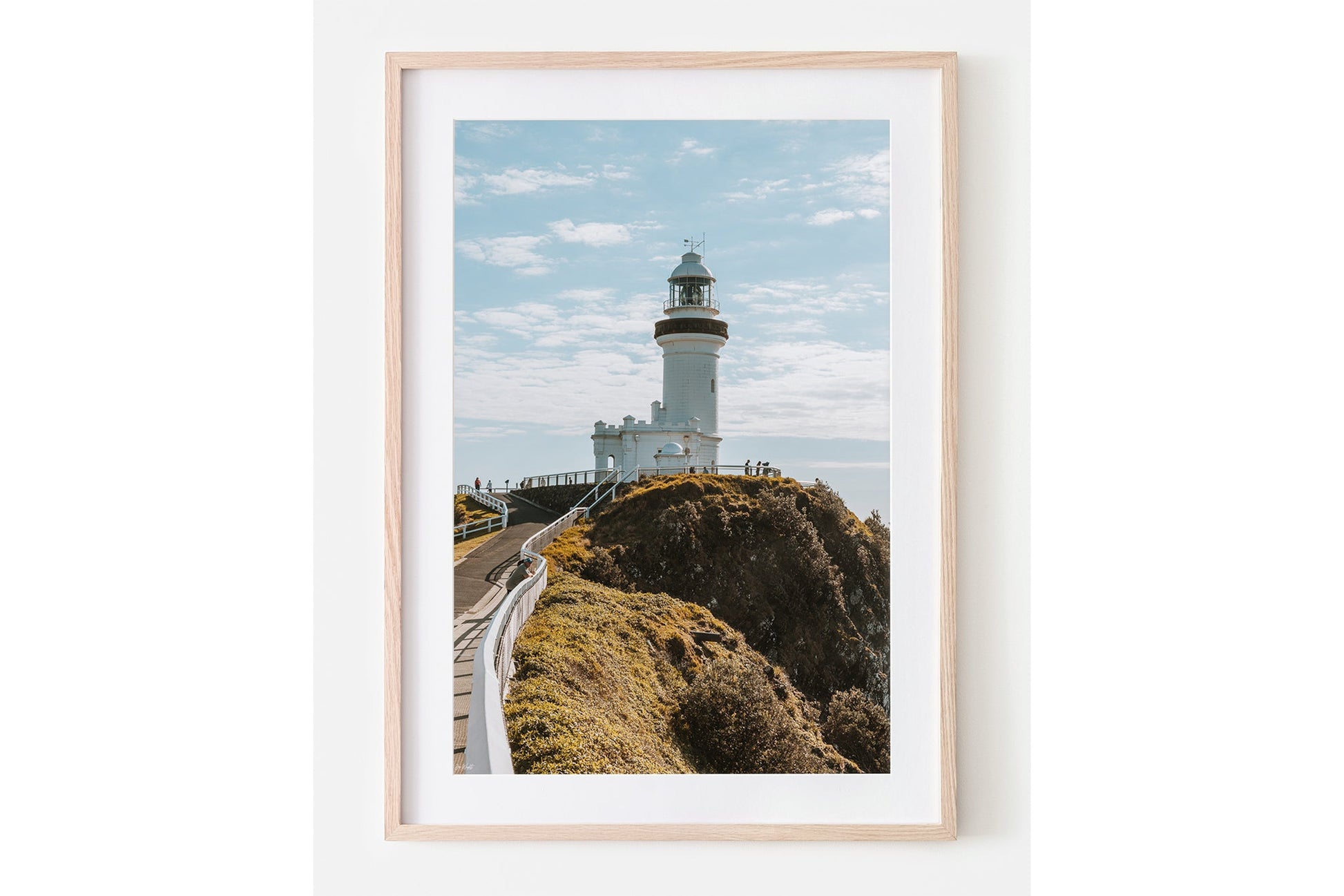 Cape Byron Lighthouse print shown framed in oak with a white mat.