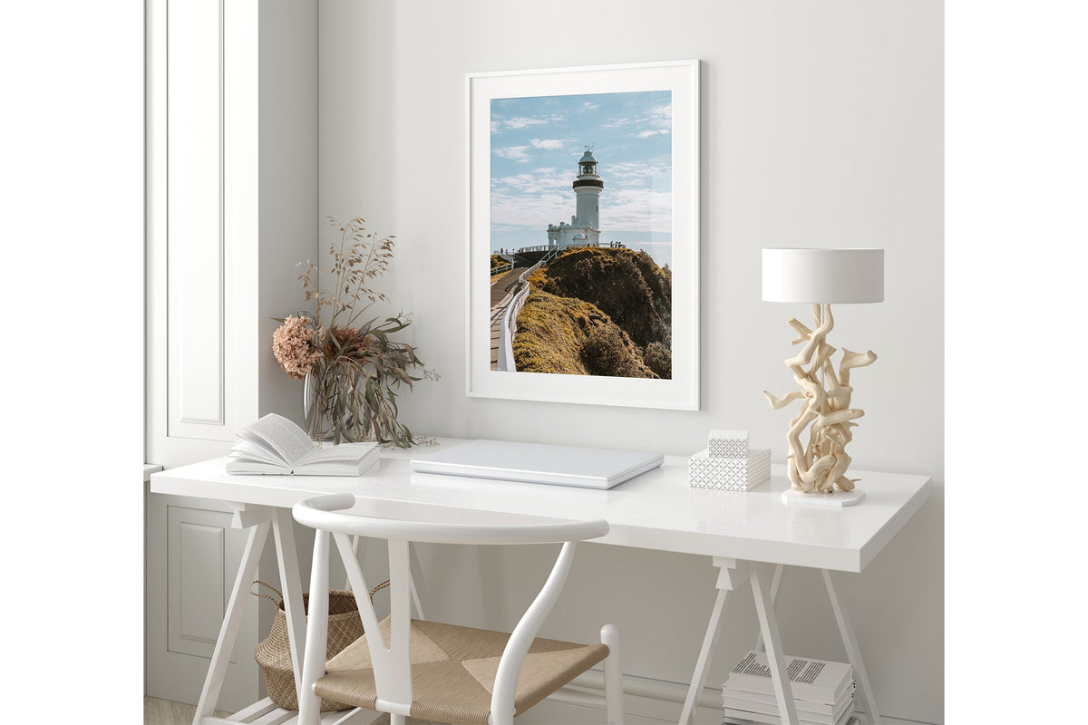 Cape Byron Lighthouse print shown framed in white in a coastal styled room.