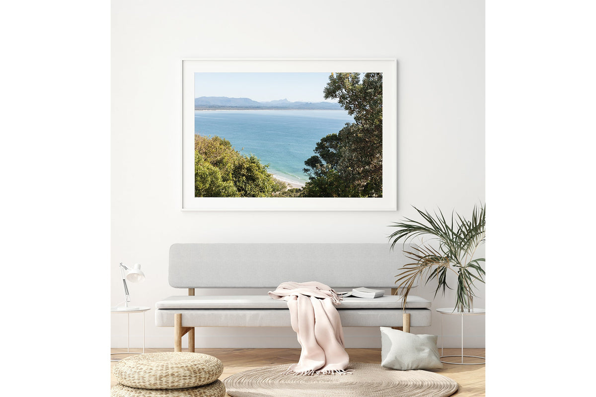 Byron Bay lookout print shown framed in white above a bench seat.