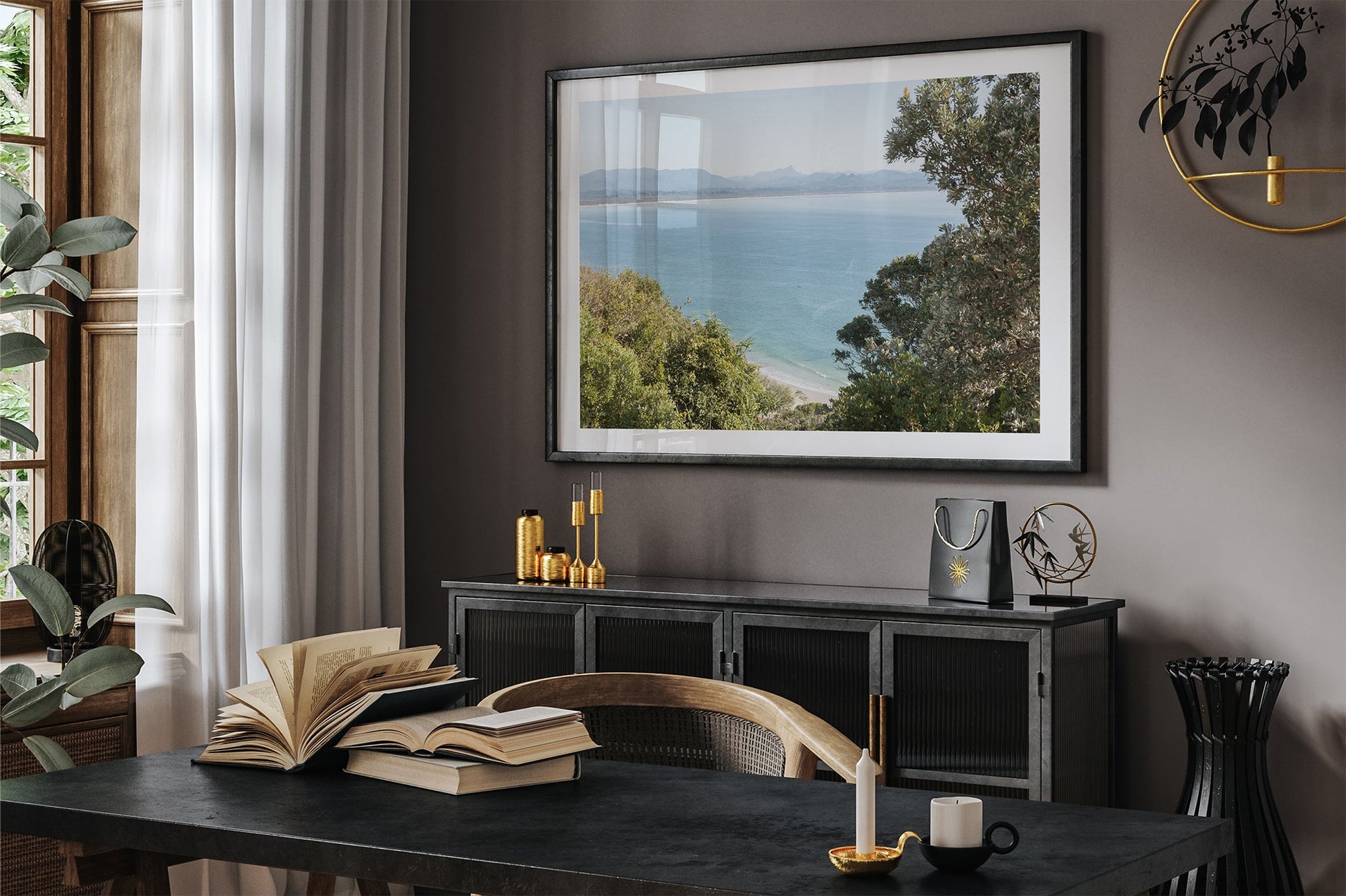 Byron Bay lookout print shown framed in black in a dark room.