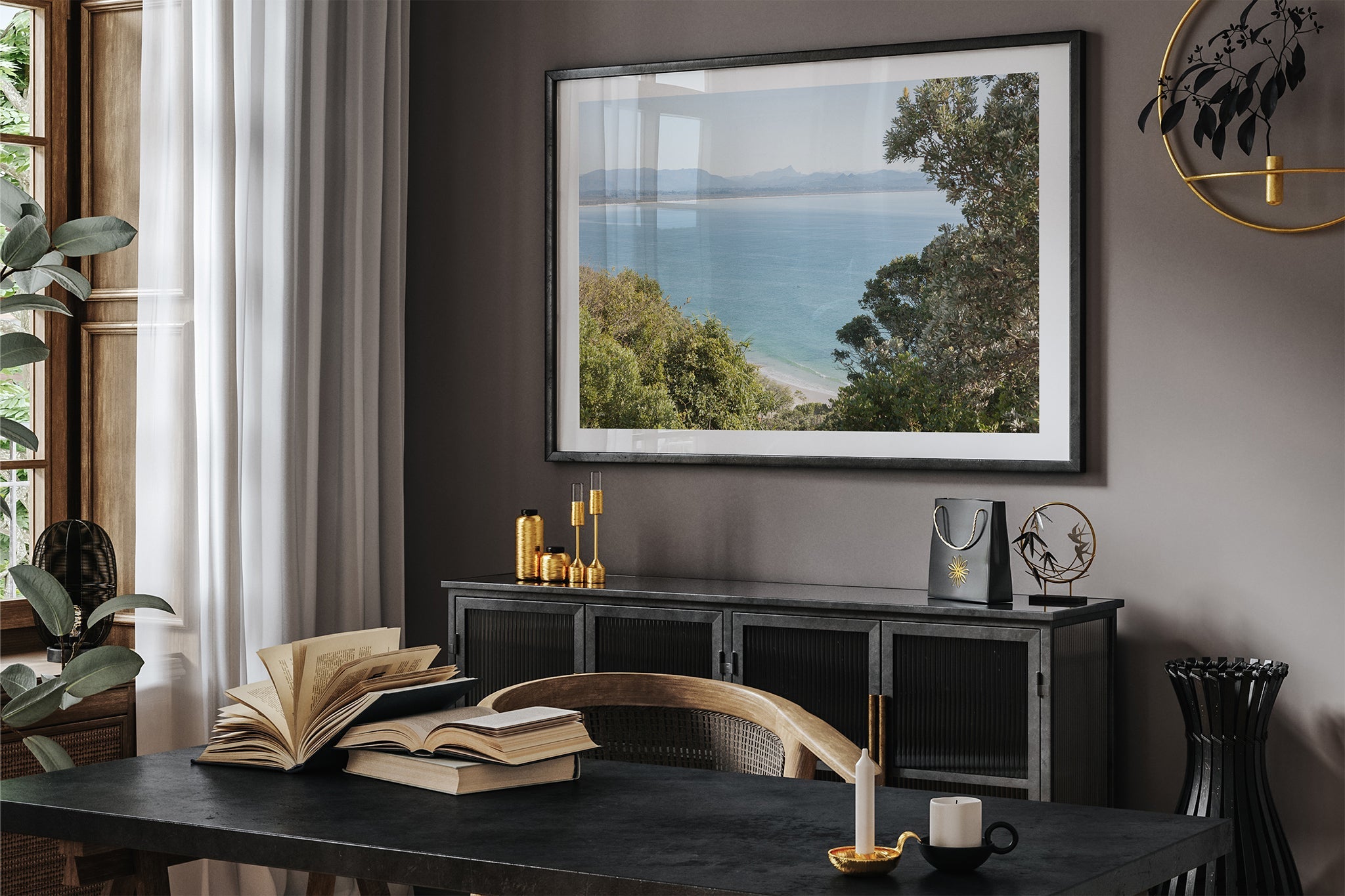 Byron Bay lookout print shown framed in black in a dark room.