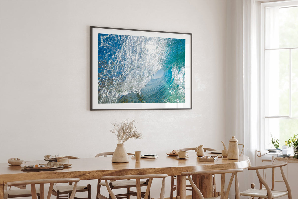 Glass Tunnel print shown framed in black above an oak table.