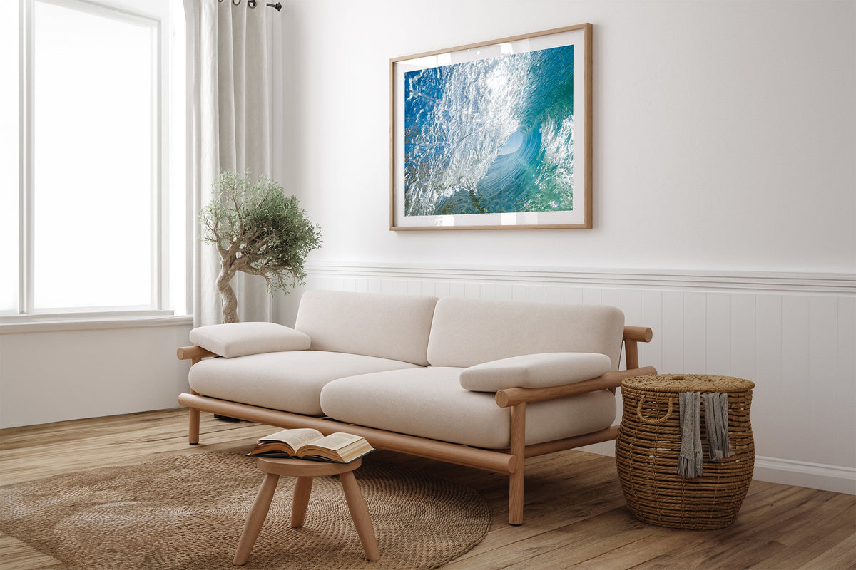 Glass Tunnel print shown framed in oak above a linen couch.