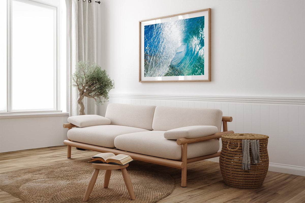 Blue Chamber print shown framed in oak above a linen couch.