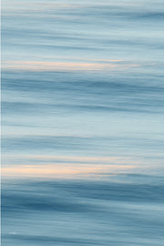 Soft sky blue and slate bands of blurred water with two thin streaks of peach light, a calm slow shutter abstract print.