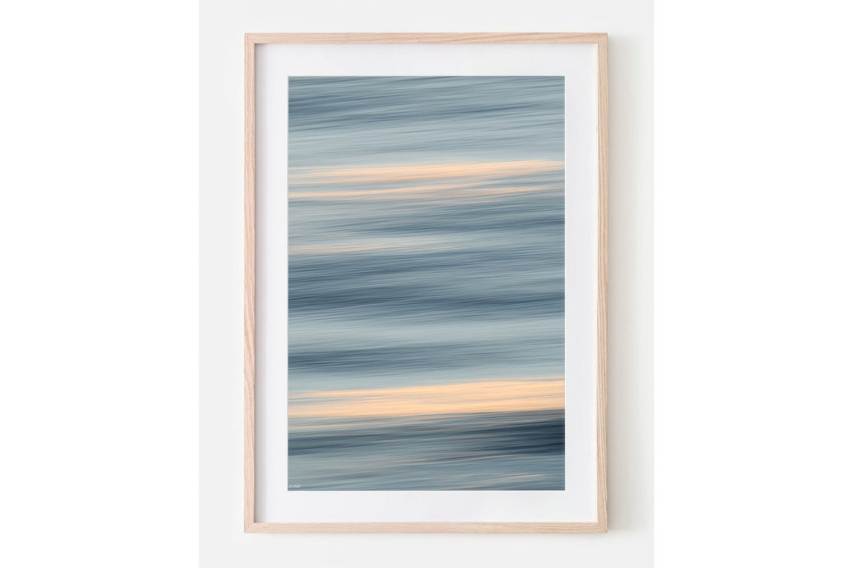 Quiet Tide print shown framed in oak with a white mat.