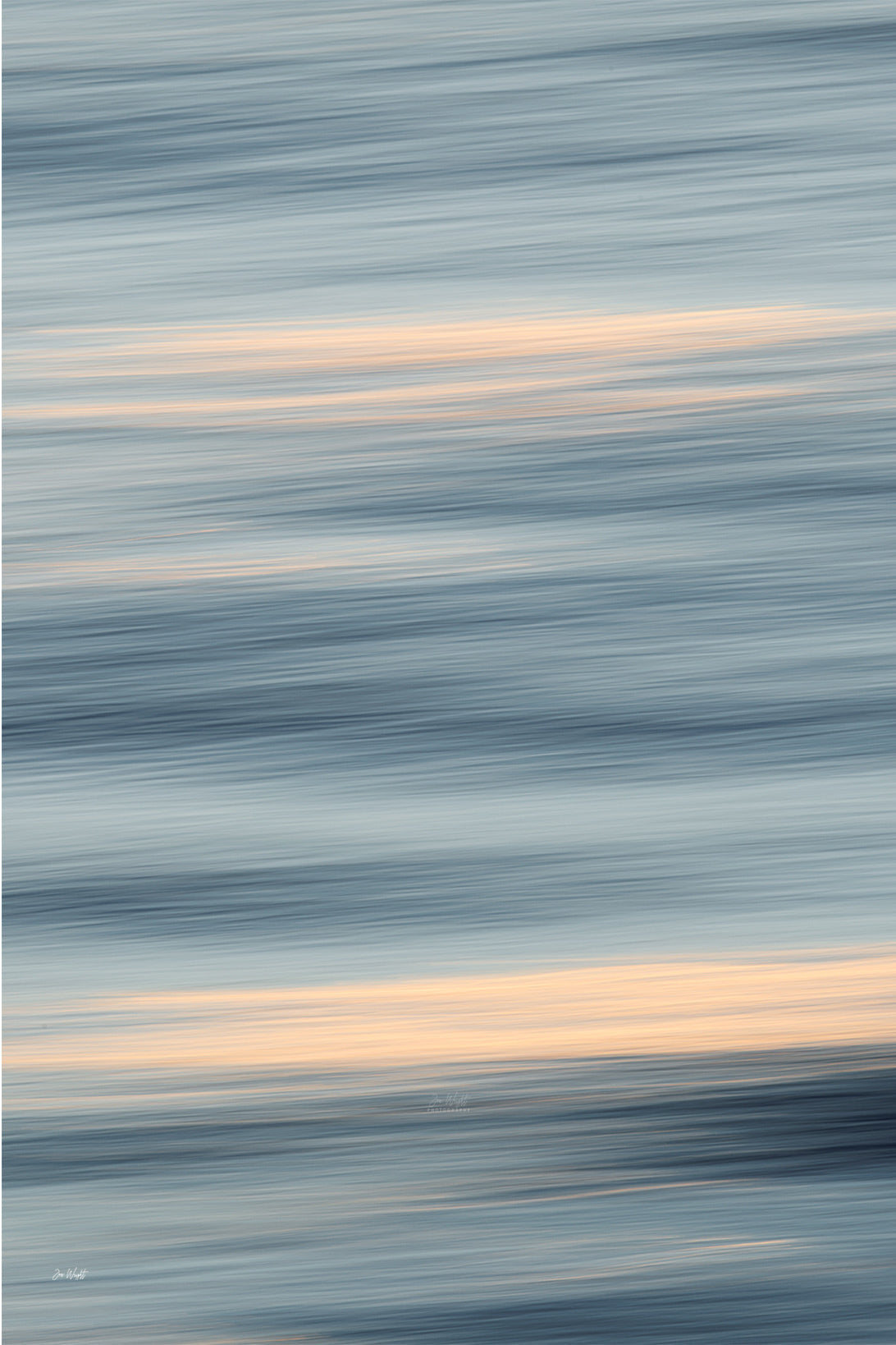 Slate blue and pale grey bands of blurred water broken by wide peach streaks of light, a restful slow shutter abstract print.