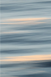 Slate blue and pale grey bands of blurred water broken by wide peach streaks of light, a restful slow shutter abstract print.