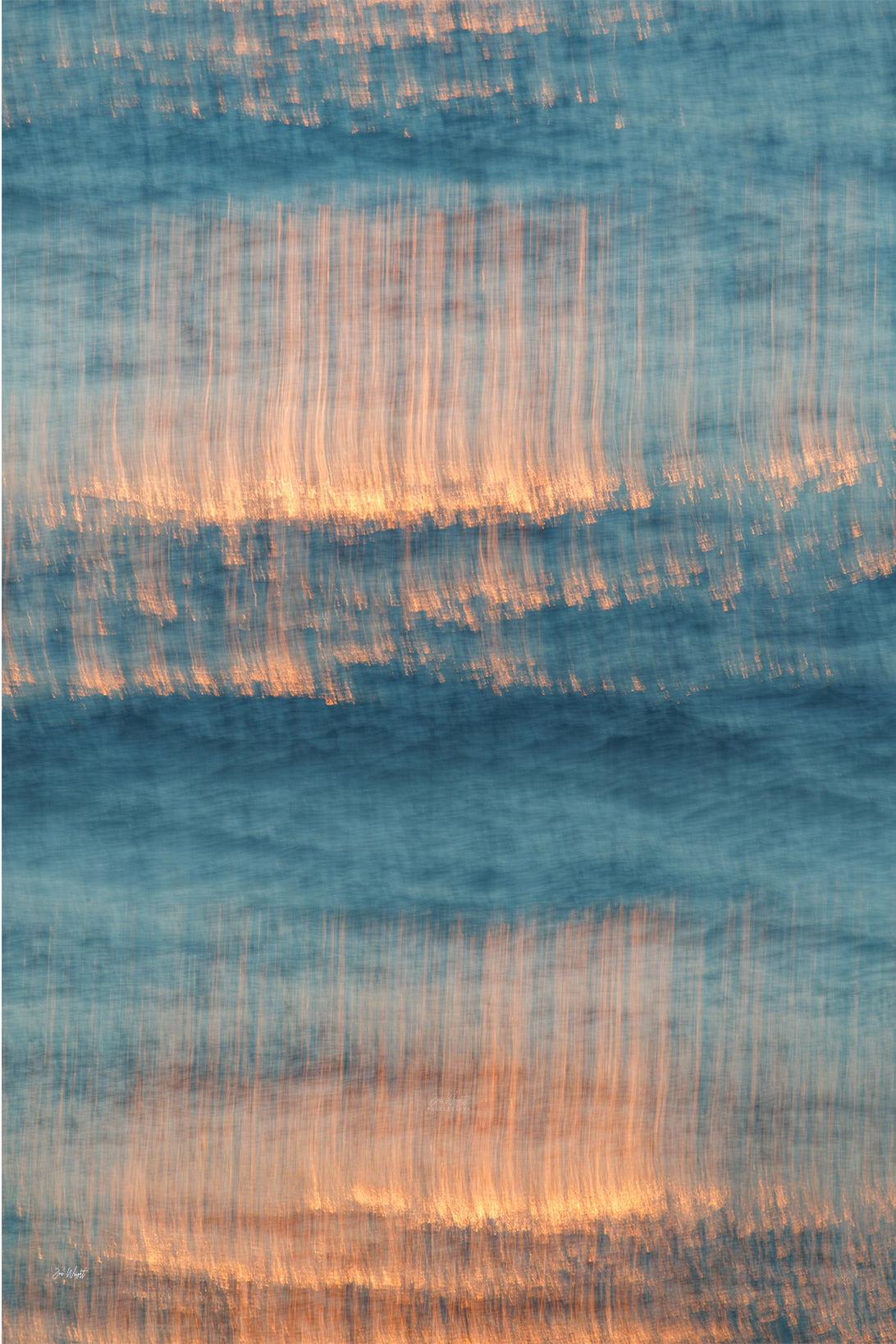 Vertical streaks of copper orange light falling through teal and blue blurred water, a slow shutter abstract wall print.
