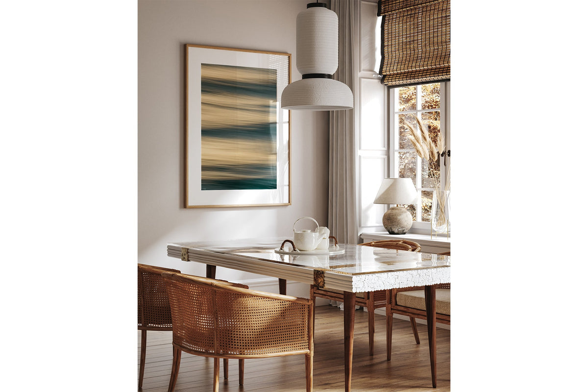 Honey Drift print shown framed in oak above a dining table.