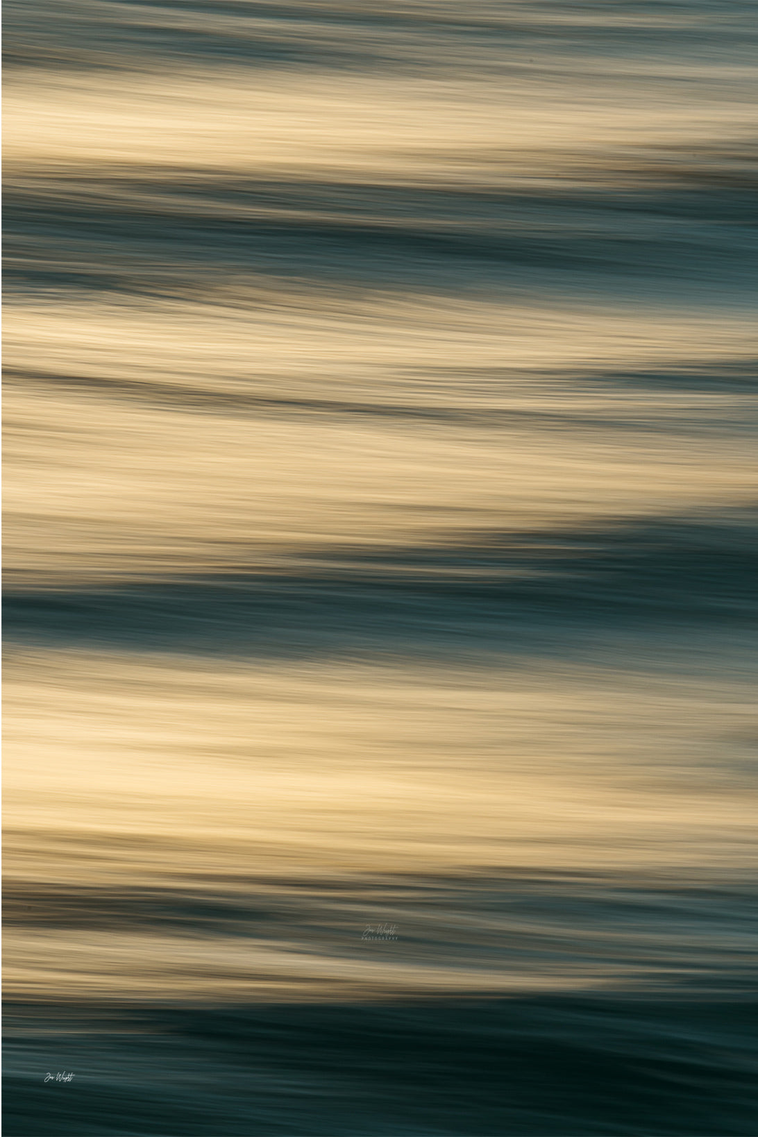 Broad bands of honey gold and cream blurred water divided by lines of dark teal and green, a warm slow shutter abstract print.