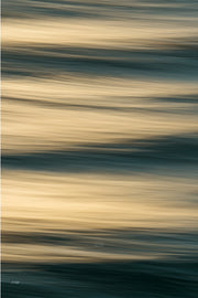 Broad bands of honey gold and cream blurred water divided by lines of dark teal and green, a warm slow shutter abstract print.