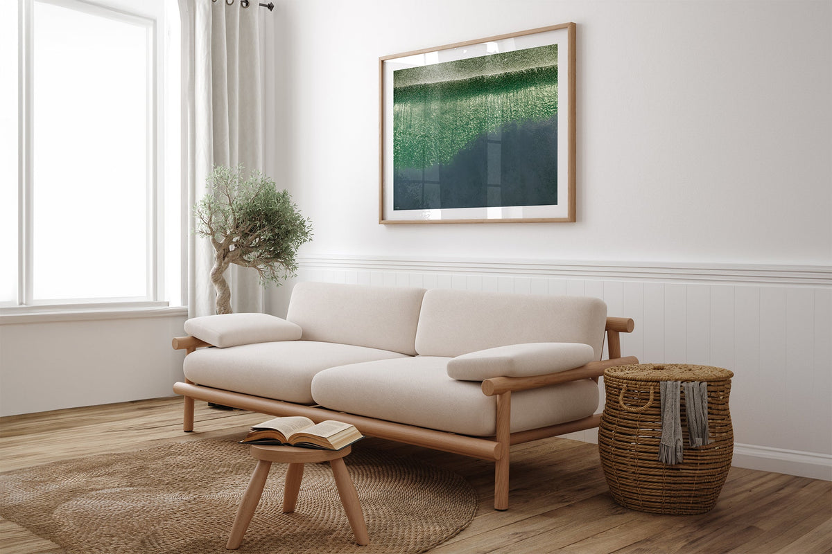Green Cascade print shown framed in oak above a linen couch.