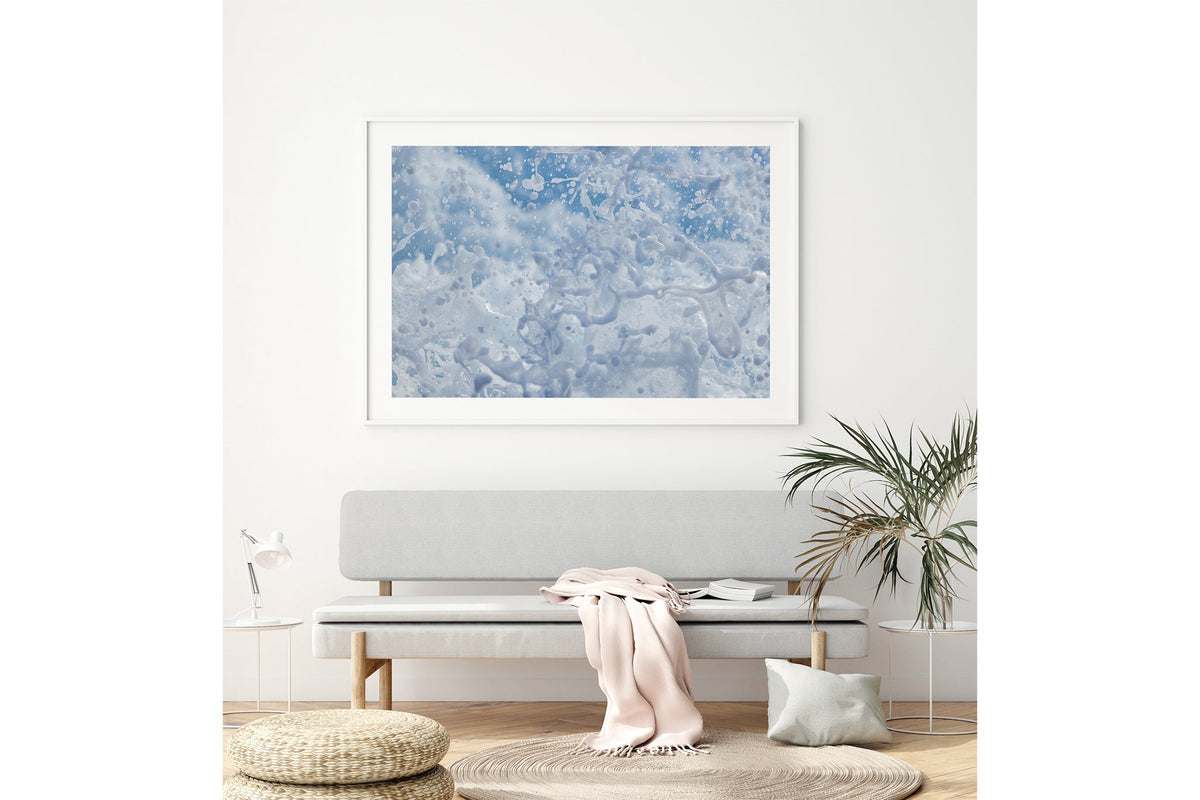 Frozen Splash print shown framed in white above a bench seat.