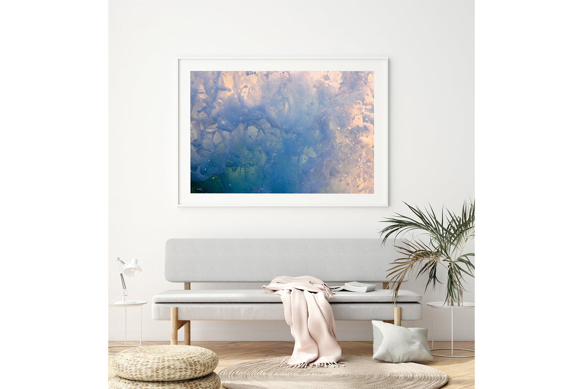 Coral Marble print shown framed in white above a bench seat.