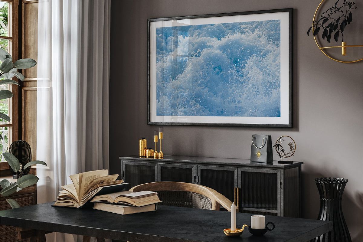 Cobalt Chaos print shown framed in black in a dark room.