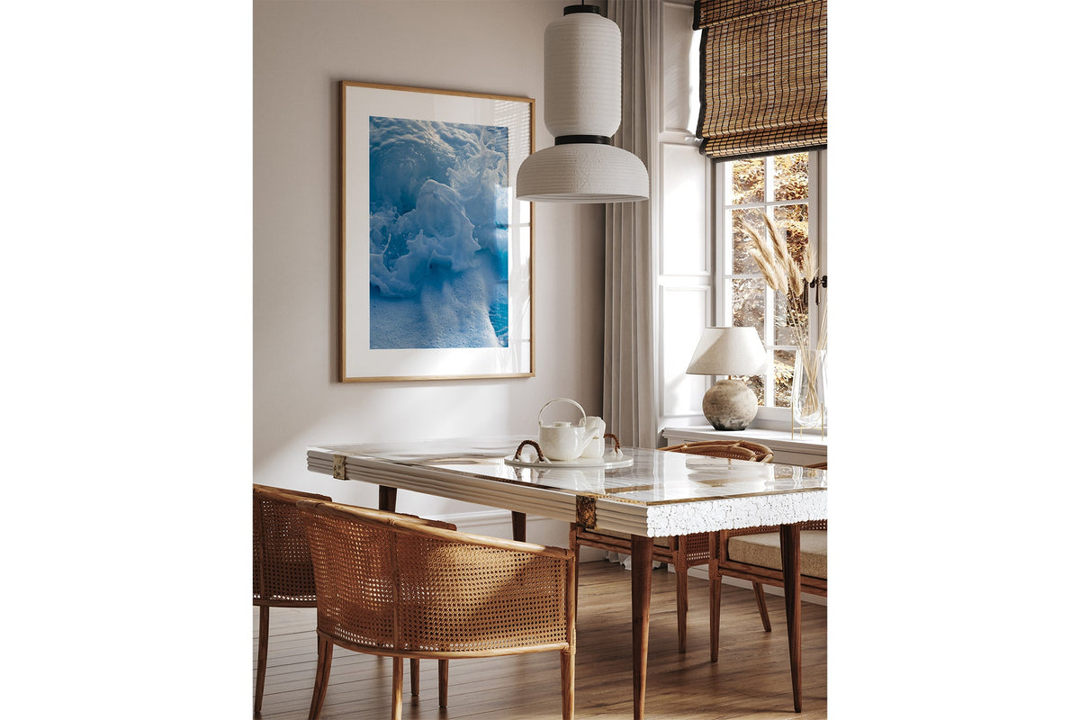 Ice Blue Foam print shown framed in oak above a dining table.