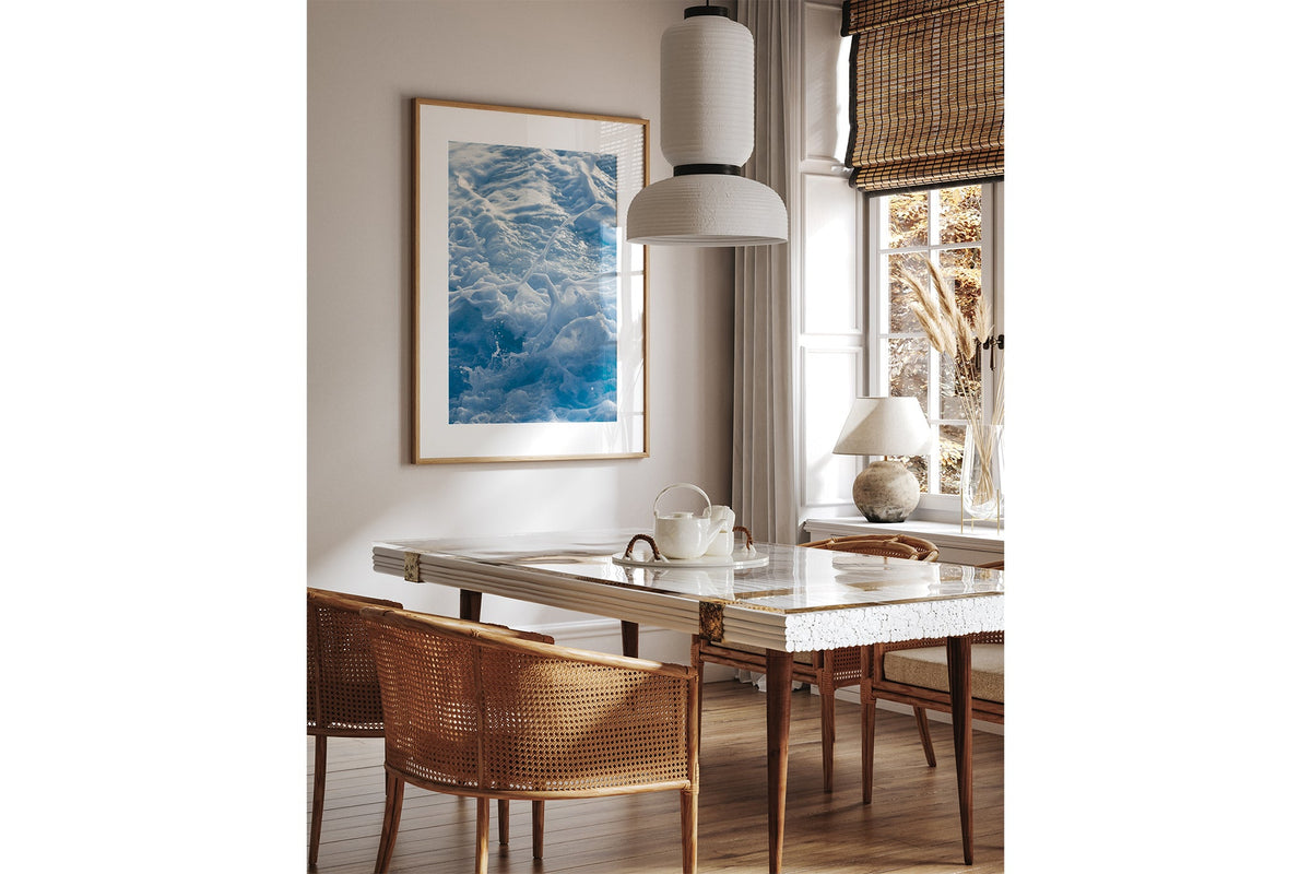 Blue Ribbon Foam print shown framed in oak above a dining table.