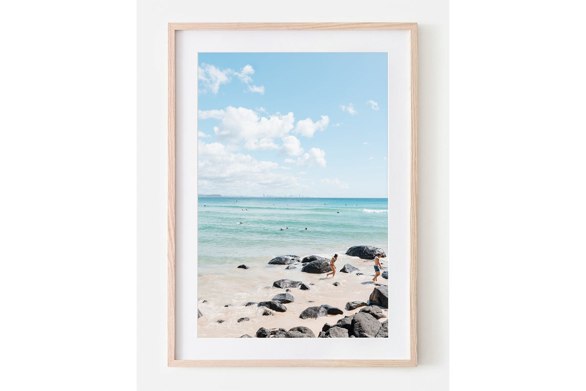 Rocky Shore Skyline print shown framed in oak with a white mat.