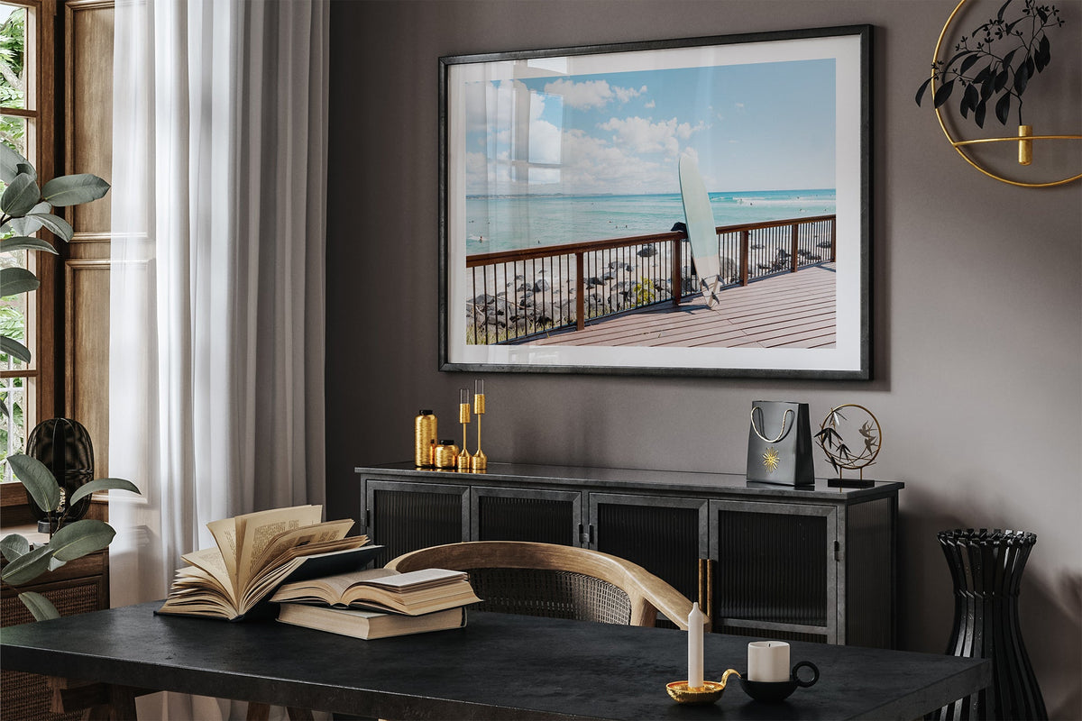 Boardwalk Break print shown framed in black in a dark room.