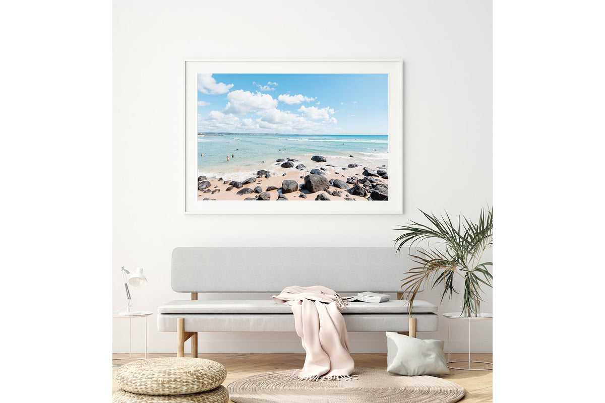 Rock Pool Shallows print shown framed in white above a bench seat.