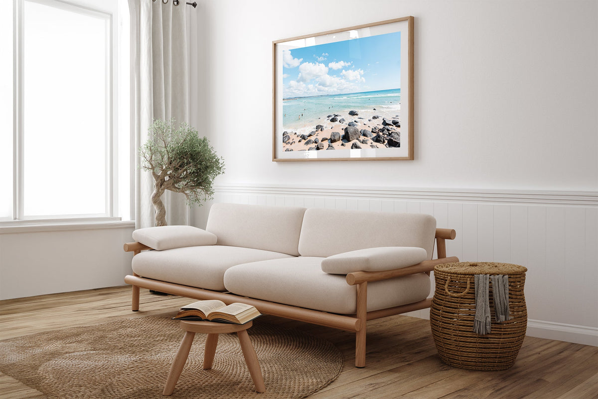 Rock Pool Shallows print shown framed in oak above a linen couch.