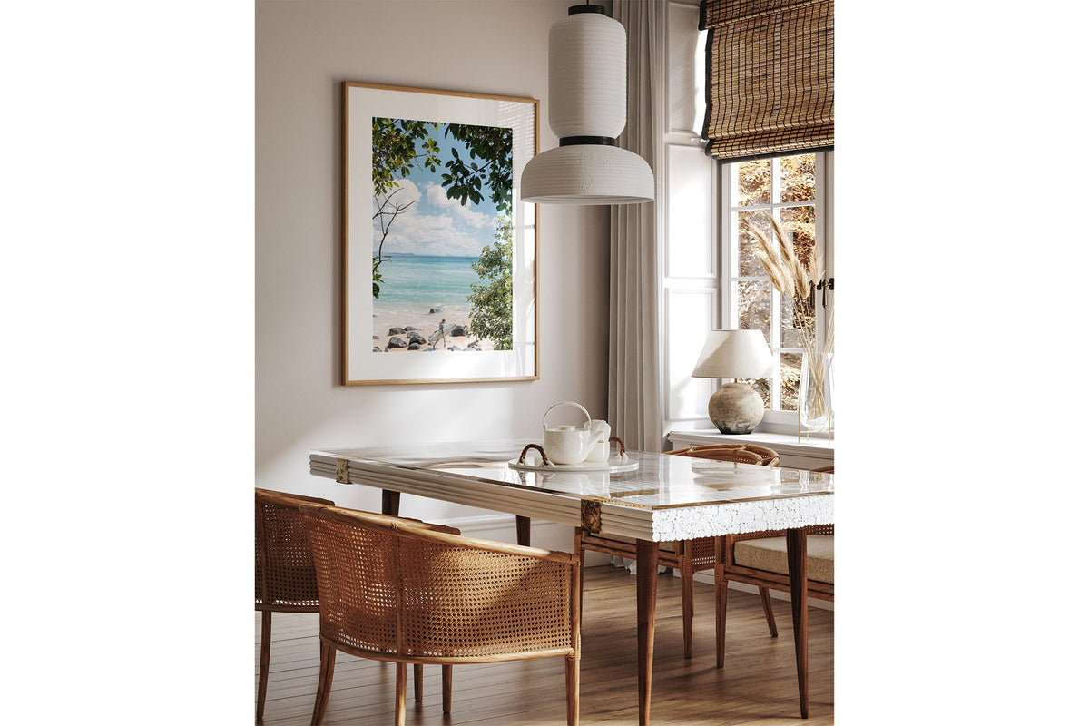 Surfer's Path print shown framed in oak above a dining table.