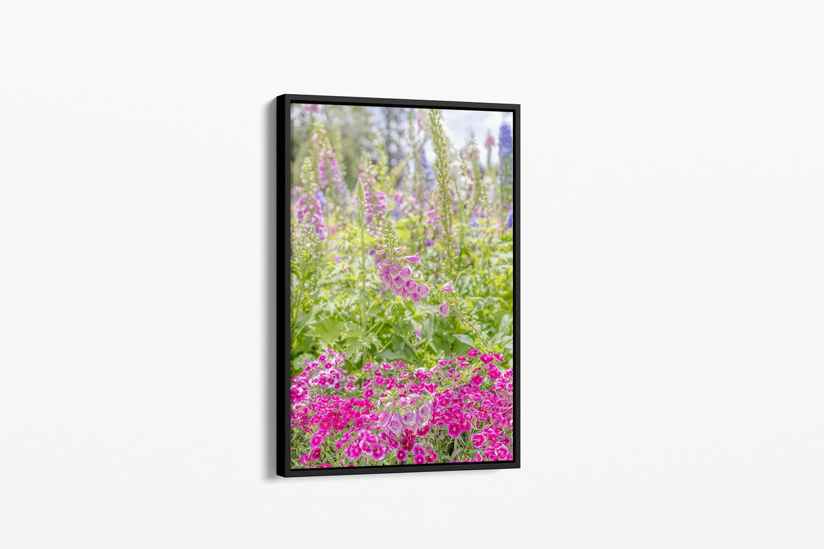 Foxglove garden print shown as a canvas in a black float frame.