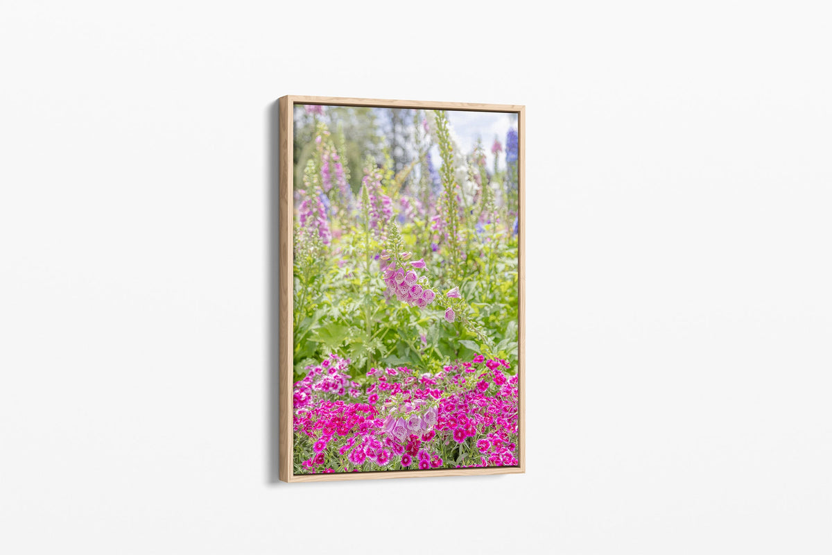 Foxglove garden print shown as a canvas in an oak float frame.