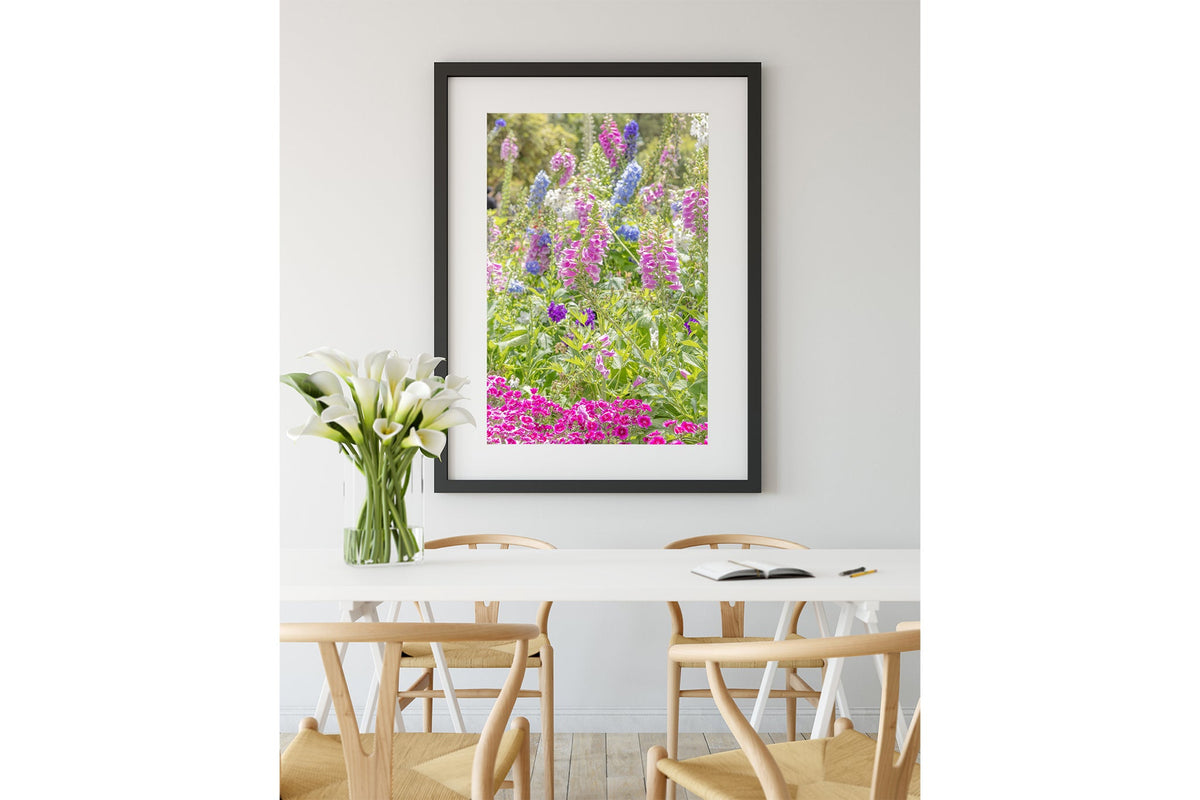 Cottage garden floral print shown framed in black.
