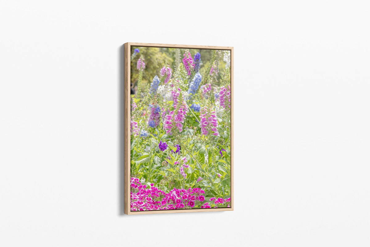 Cottage garden floral print shown as a canvas in an oak float frame.