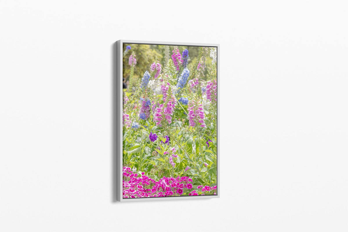 Cottage garden floral print shown as a canvas in a white float frame.
