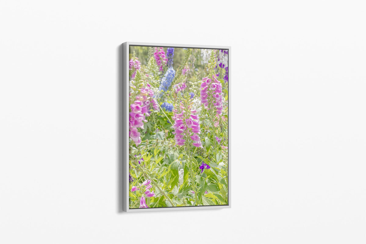 Foxglove and delphinium print shown as a canvas in a white float frame.