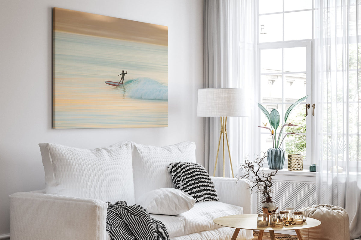 Longboard surfer print shown as a canvas in a bright white room.