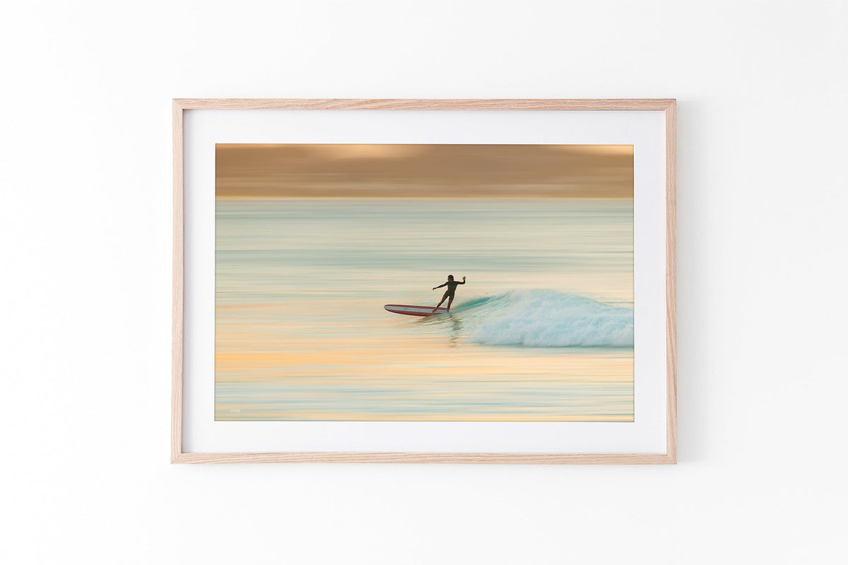 Longboard surfer print shown framed in oak.