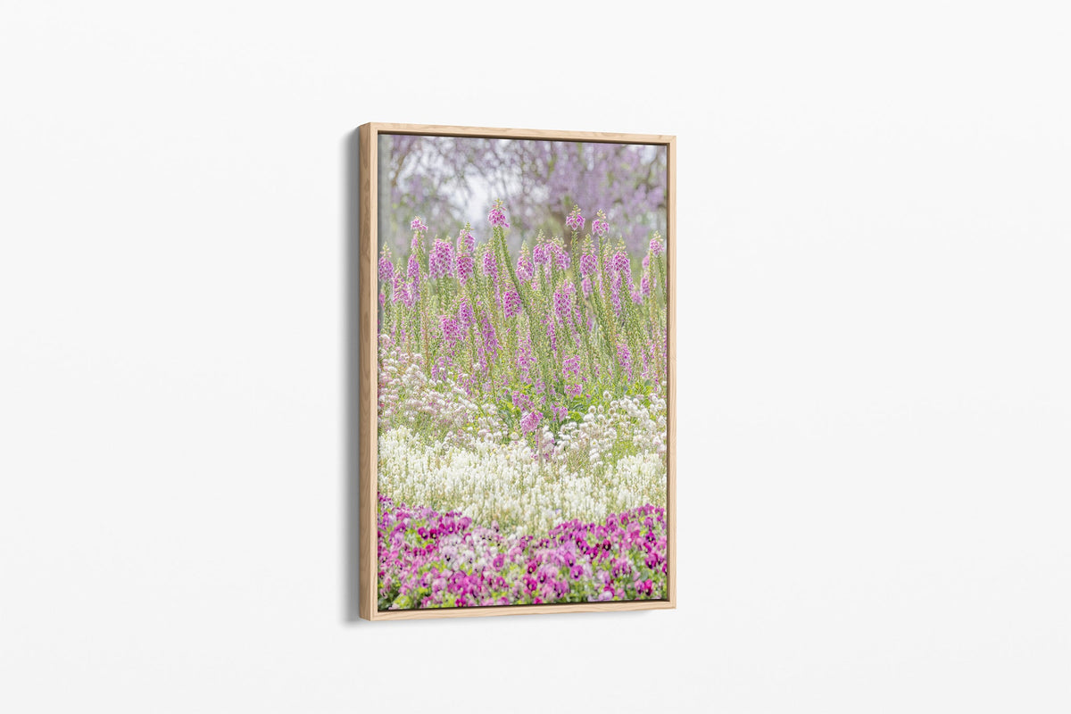Foxglove garden layers print shown as a canvas in an oak float frame.